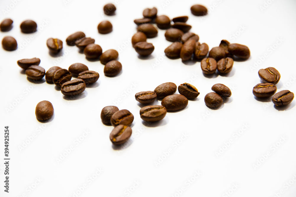 Roasted coffee beans heap isolated on white background Roasted coffee beans heap isolated on white background
