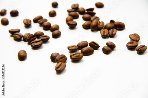 Roasted coffee beans heap isolated on white background