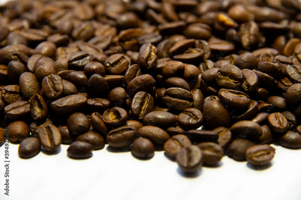 Roasted coffee beans heap isolated on white background can be used as background Roasted coffee beans heap isolated on white background can be used as background