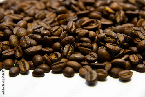 Roasted coffee beans heap isolated on white background can be used as background