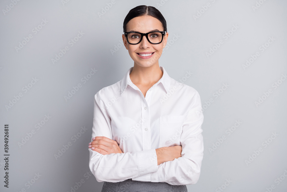 Photo of confident chief lady folded hands toothy smile wear specs white shirt isolated grey color background Photo of confident chief lady folded hands toothy smile wear specs white shirt isolated grey color background