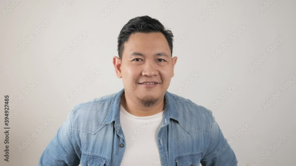 Young happy successful Asian man smiling at camera. Confident good looking positive person Young happy successful Asian man smiling at camera. Confident good looking positive person