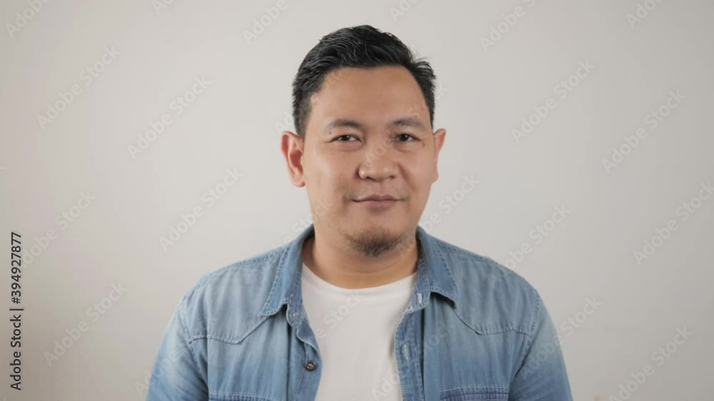 Young happy successful Asian man smiling at camera. Confident good looking positive person Young happy successful Asian man smiling at camera. Confident good looking positive person