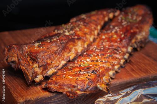 smoked pork rack barbeque on woodenn board photo