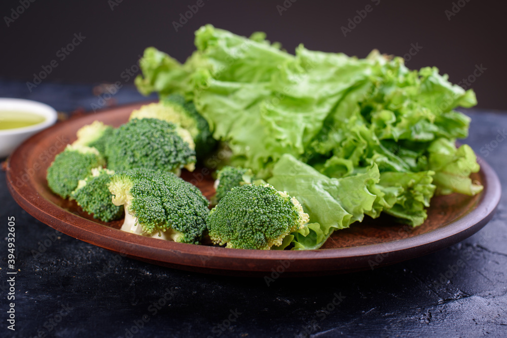 A plate of healthy and delicious food from fresh lettuce, and cabbage. Useful fiber for the body in food. Group of Raw Fresh Organic Green Vegetables A plate of healthy and delicious food from fresh lettuce, and cabbage. Useful fiber for the body in food. Group of Raw Fresh Organic Green Vegetables