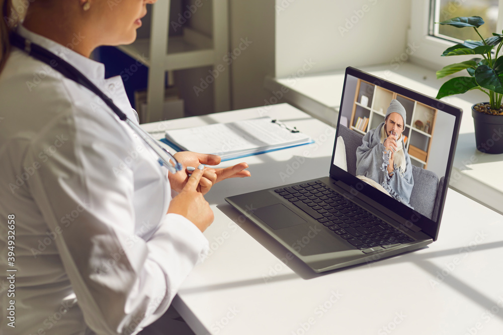 Woman doctor in medical uniform telling recommendation to young ill man patient online Woman doctor in medical uniform telling recommendation to young ill man patient online