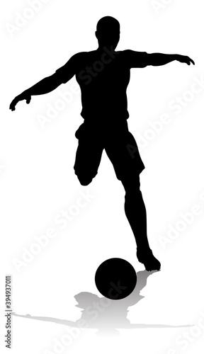 A soccer or football player in silhouette