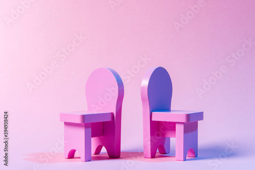 Empty Chairs Against Pink Background