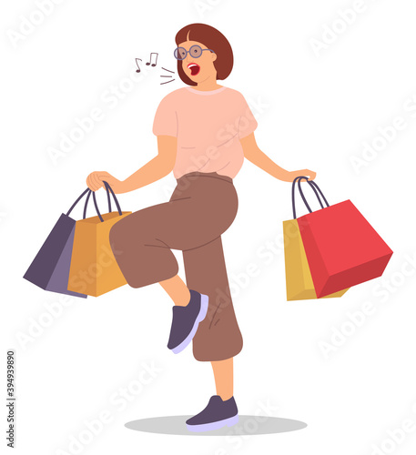 Woman with shopping bags is smiling. Young beautiful fashion shopper girl is singing songs. Sale advertising concept. Female character with packages in her hands is standing on white background