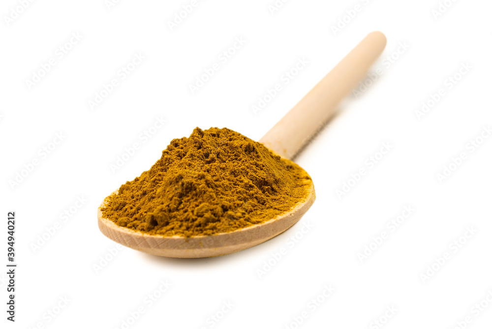 Curry in wooden spoon isolated on white. Curry in wooden spoon isolated on white.