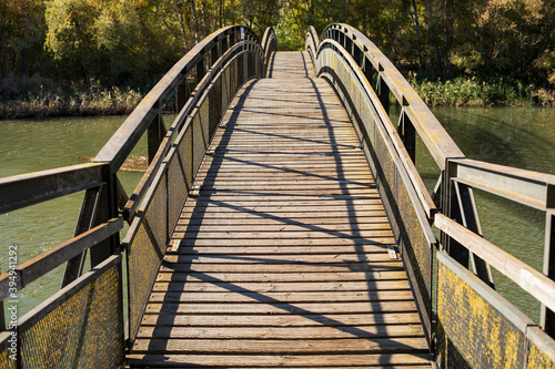 Fototapeta Naklejka Na Ścianę i Meble -  Wooden bridge over a river.