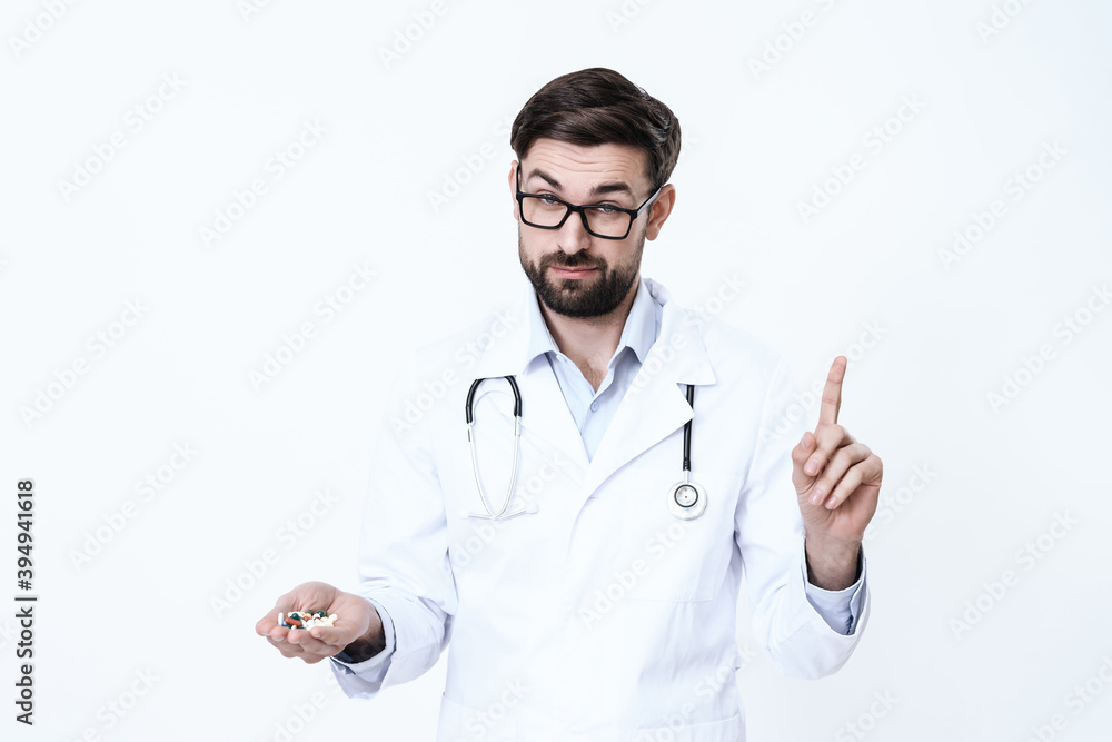 Man in glasses stands with pills. Man in glasses stands with pills.