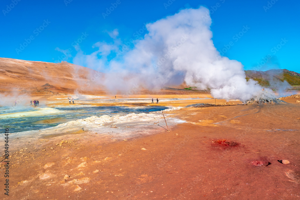 Geothermal active zone Hverir near Myvatn lake in Iceland, resembling Martian red planet landscape, at summer and blue sky.