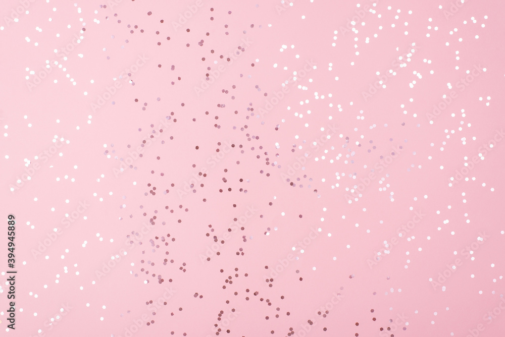 Feminine glamorous pastel color pink background with white shiny confetti