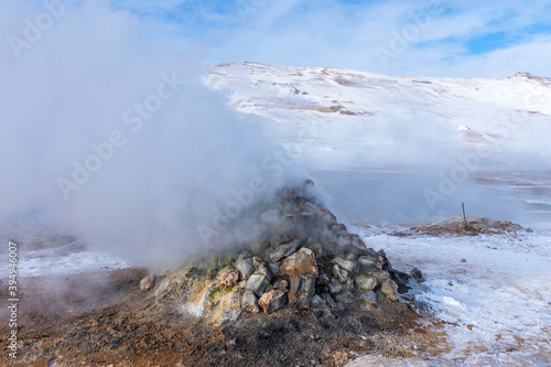 Winter landscape view of the geothermal region Hverir near Myvatn Lake in Iceland. A geothermal area with boiling mud pools and steaming fumaroles Hverir near Myvatn Lake in Iceland.