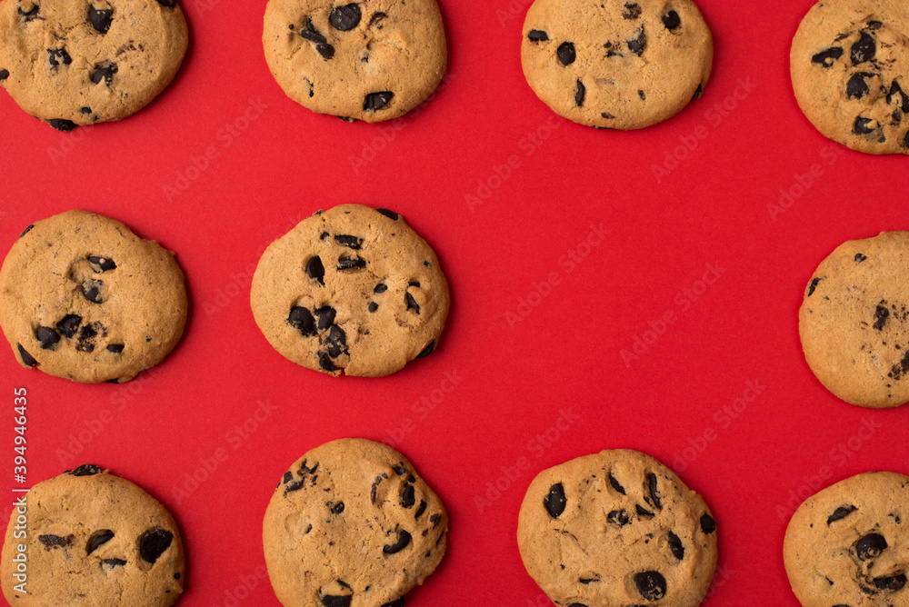 Close up photo of yummy fresh handmade cookies with chocolate chips lying in rows with an empty place for one isolated bright color background Close up photo of yummy fresh handmade cookies with chocolate chips lying in rows with an empty place for one isolated bright color background
