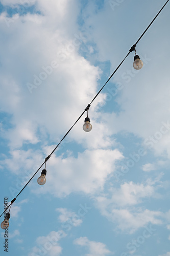 Light bulb garland with blue sky, beautiful background..