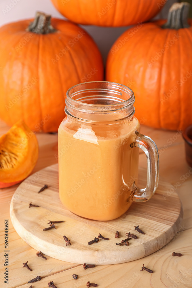 Mason jar of tasty pumpkin smoothie on table Mason jar of tasty pumpkin smoothie on table