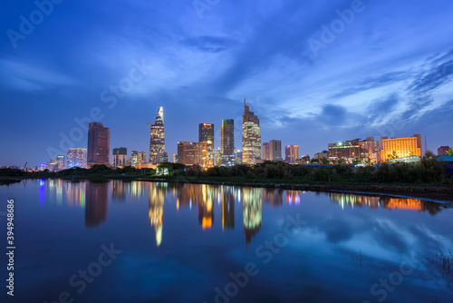 Night view of Ho Chi Minh city with reflection on water, Vietnam.