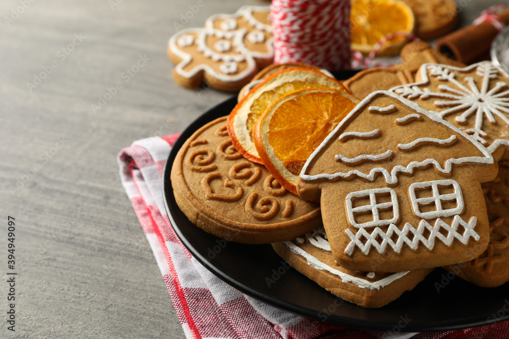 Concept of holiday food with Christmas cookie on gray table