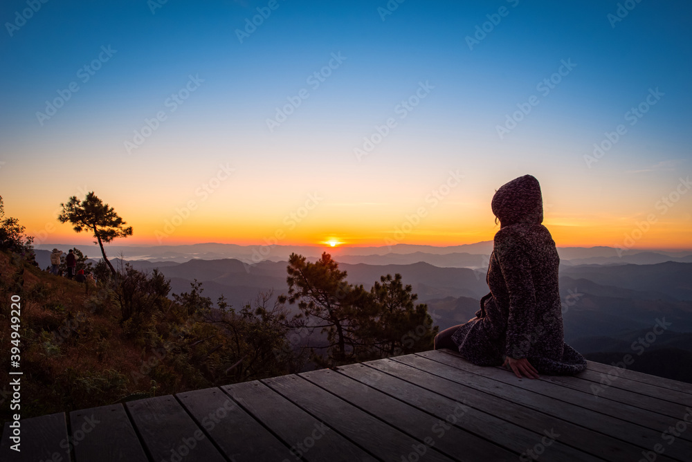 Traveller looking sunrise scene with the peak of mountain and Mist at Phu chi phe in Mae Hong Son Province,Thailand