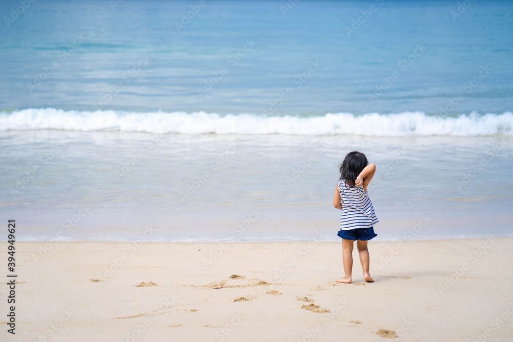 Active little girl playing at sea shore in Phang Nga Thailand.