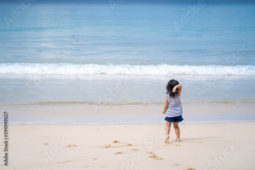 Active little girl playing at sea shore in Phang Nga Thailand.