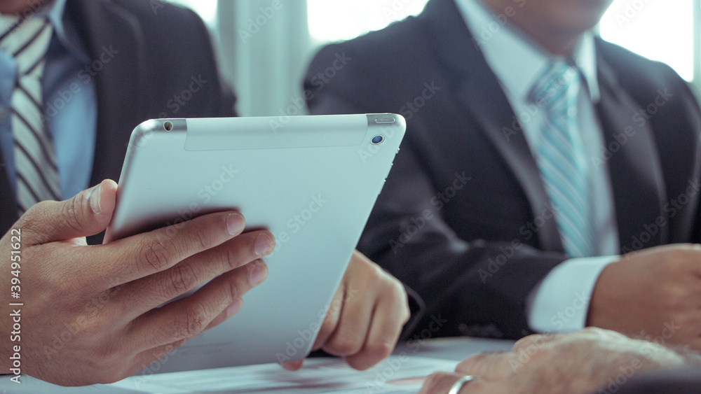 Businessmen wear a suit in a modern office using a tablet to study a projector, a businessman uses a tablet in a modern office. Businessmen wear a suit in a modern office using a tablet to study a projector, a businessman uses a tablet in a modern office.