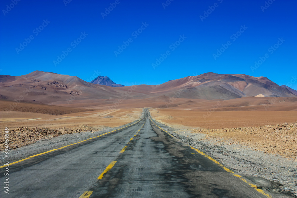 road leading into mountains in altiplano desert