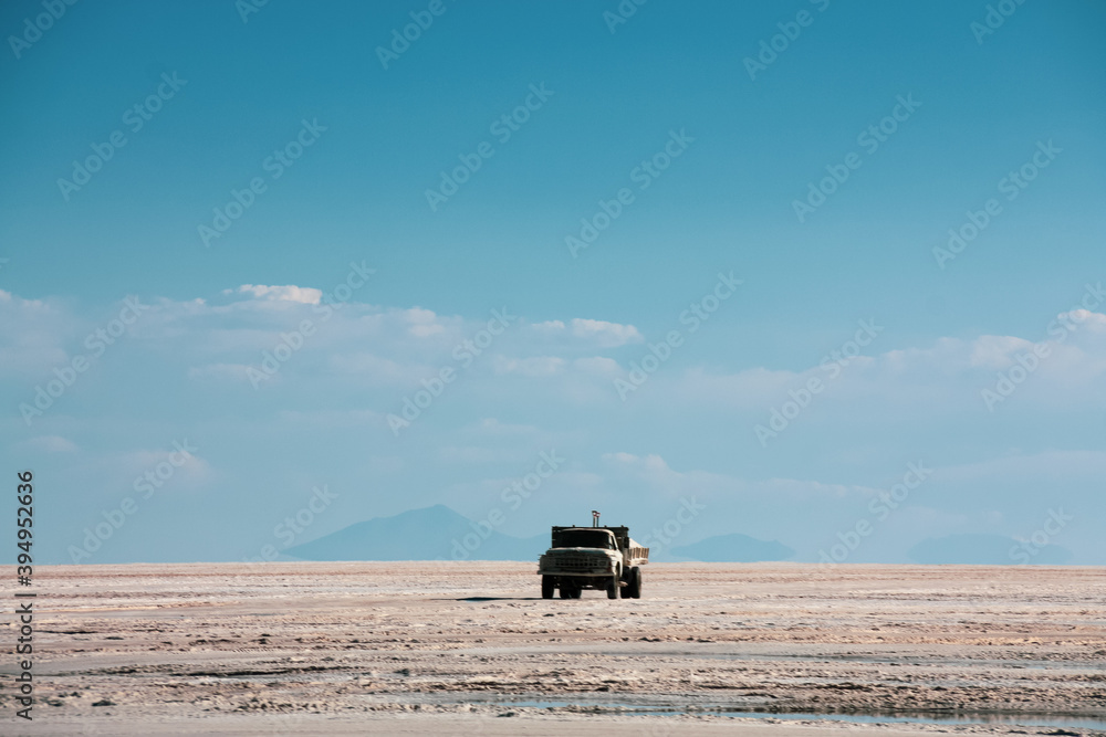 Fototapeta premium Truck transporting salt on Uyuni salt lake in Bolivia