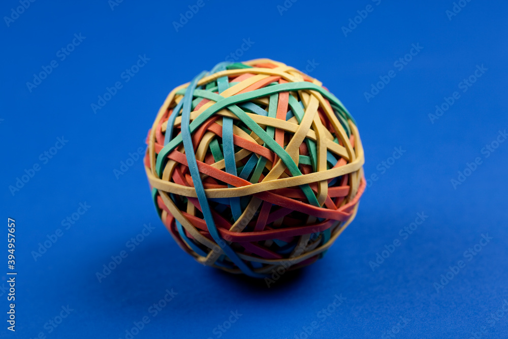 Studio photo of one rubber band ball on colorful blue background. Studio photo of one rubber band ball on colorful blue background.