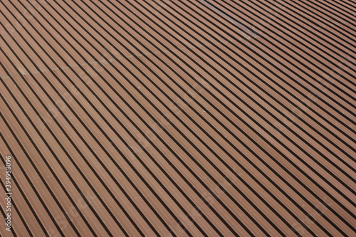 Seamless pattern of metal sheet roof brown color. Metal sheet roof line arrange pattern texture background.