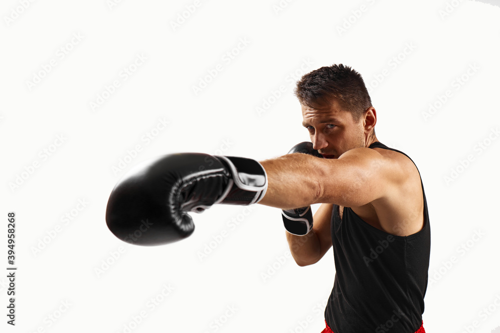 sporty man in black boxing gloves punching isolated on white background.