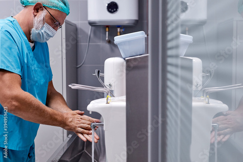 professional doctor wash hands before surgery operation, clean the dirt. in sterile operating room photo