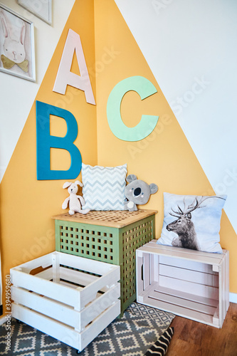 Stylish children's room with boxes and toys modern interior with letters. The concept of room for the baby. © Svetlana