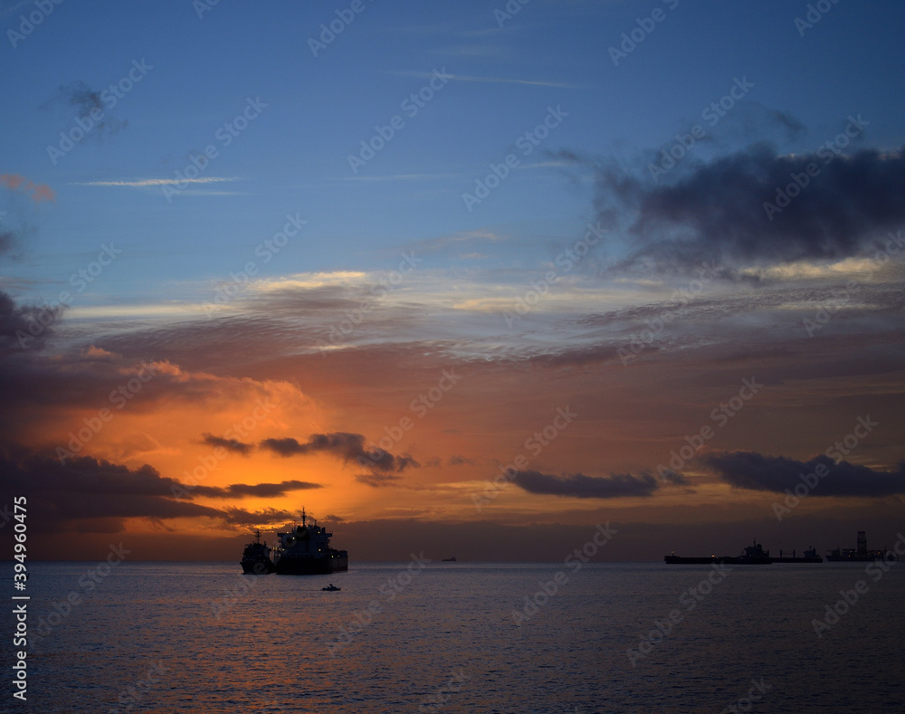 Sunrise from the sea with amazing sky, ships and low clouds Sunrise from the sea with amazing sky, ships and low clouds