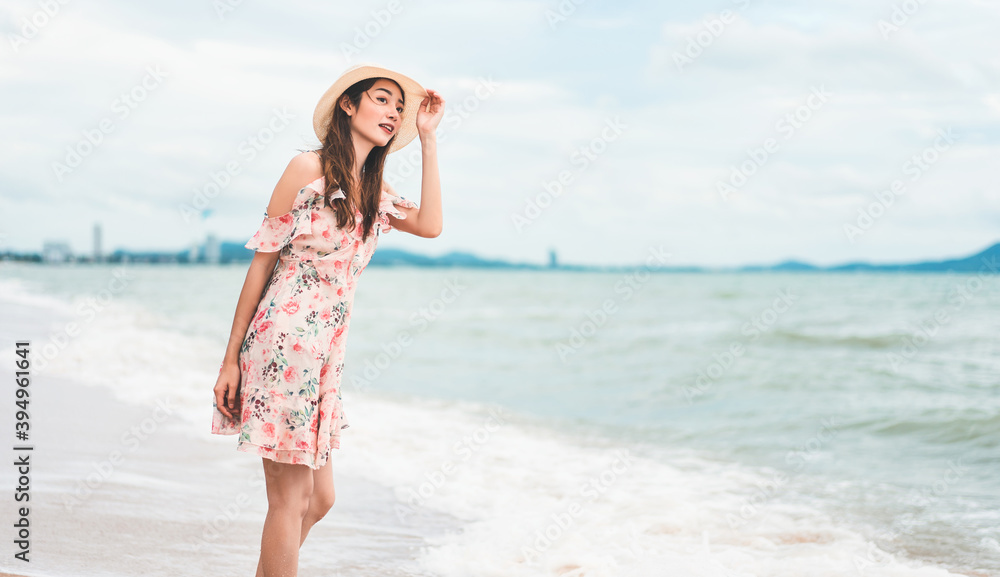 Young asian beautiful woman walk and relax on the beach sand. Young asian beautiful woman walk and relax on the beach sand.