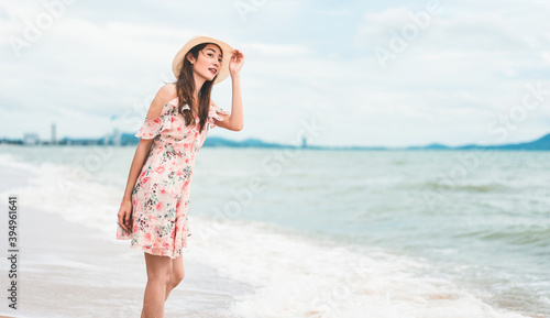 Young asian beautiful woman walk and relax on the beach sand.