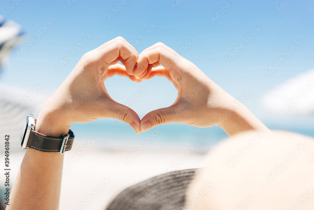 Rear view of asian traveller woman hand with heart gesture for love. Rear view of asian traveller woman hand with heart gesture for love.