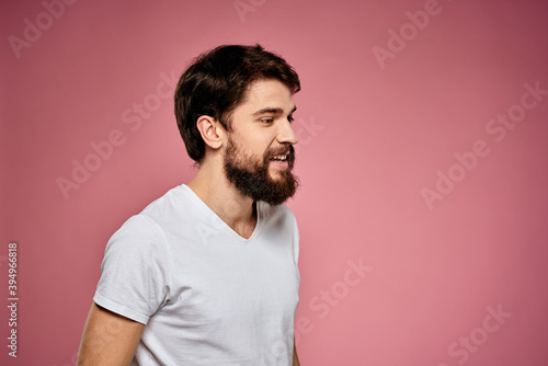 Man in white t-shirt emotions lifestyle facial expression cropped view pink background.