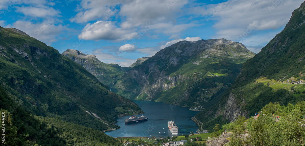 cruise ships docked at the end of a fjord in a small Norwegian town