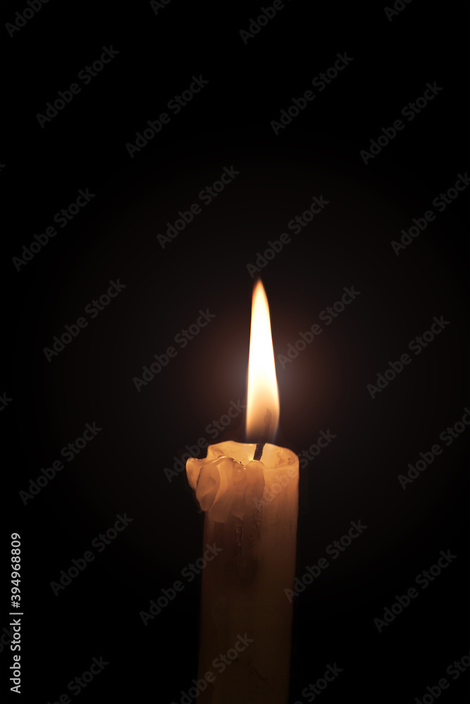 The burning candle flame on the dark background The burning candle flame on the dark background