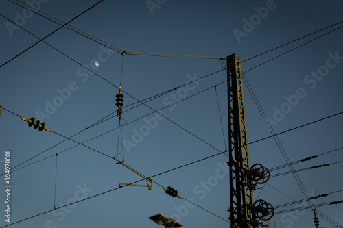 Sky moon wires lines abstract poles night structures shapes leading train station Rosenheim full half moon