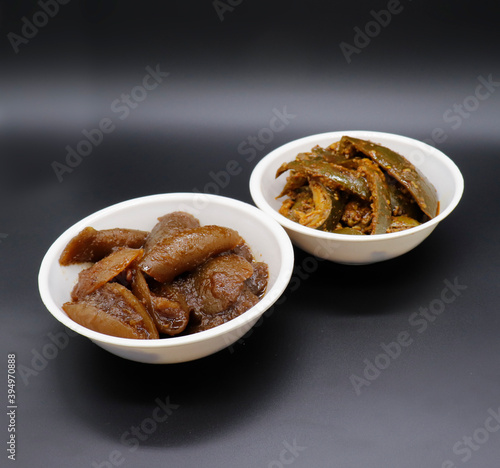 Group Photograph Of Indian Pickles Or Achar Like Lemon Pickle And Mango Pickle, Nimbu Or Aam Ka Achar Sarved In White Ceramic Bowl Selective Focus photo