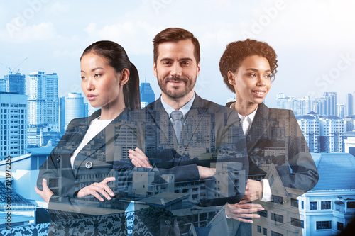 Photography Front view of three successful smiling business consultants standing in a row in suits and ready to tackle with customer problem