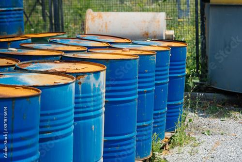 Big oil drums, blue. Chemical barrels in an open warehouse. Rusty barrels. Barrel for oil