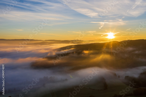 sun rise in the Bavarian forest with fog swathes in pastel colours