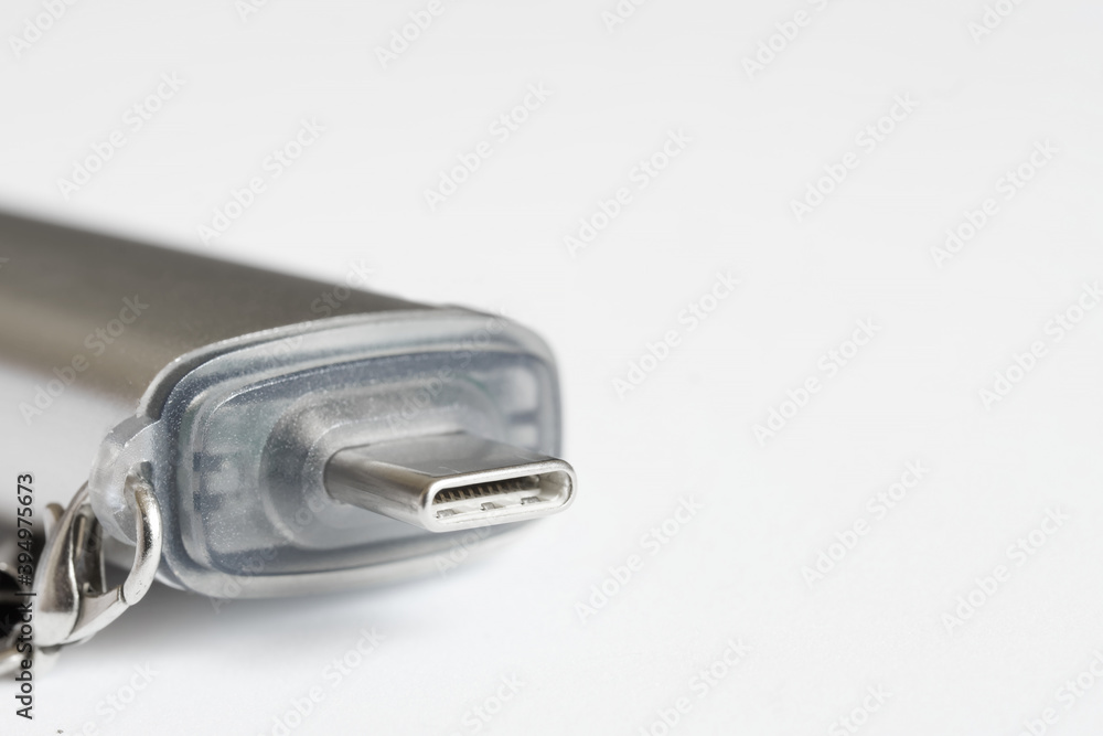 A miniature OTG adapter and card reader for the USB type-c connector and port lies on a white background. Free space for inscription. Shallow depth of field. A miniature OTG adapter and card reader for the USB type-c connector and port lies on a white background. Free space for inscription. Shallow depth of field.