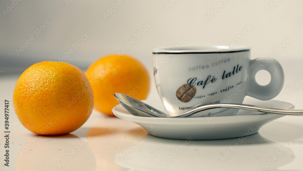 Cup of coffee with tangerines and spoon Cup of coffee with tangerines and spoon