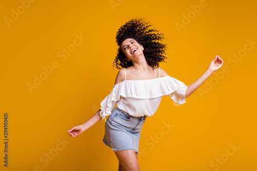 Photo of positive pretty brown hair girl dancing wear cool outfit isolated on vivid yellow color background